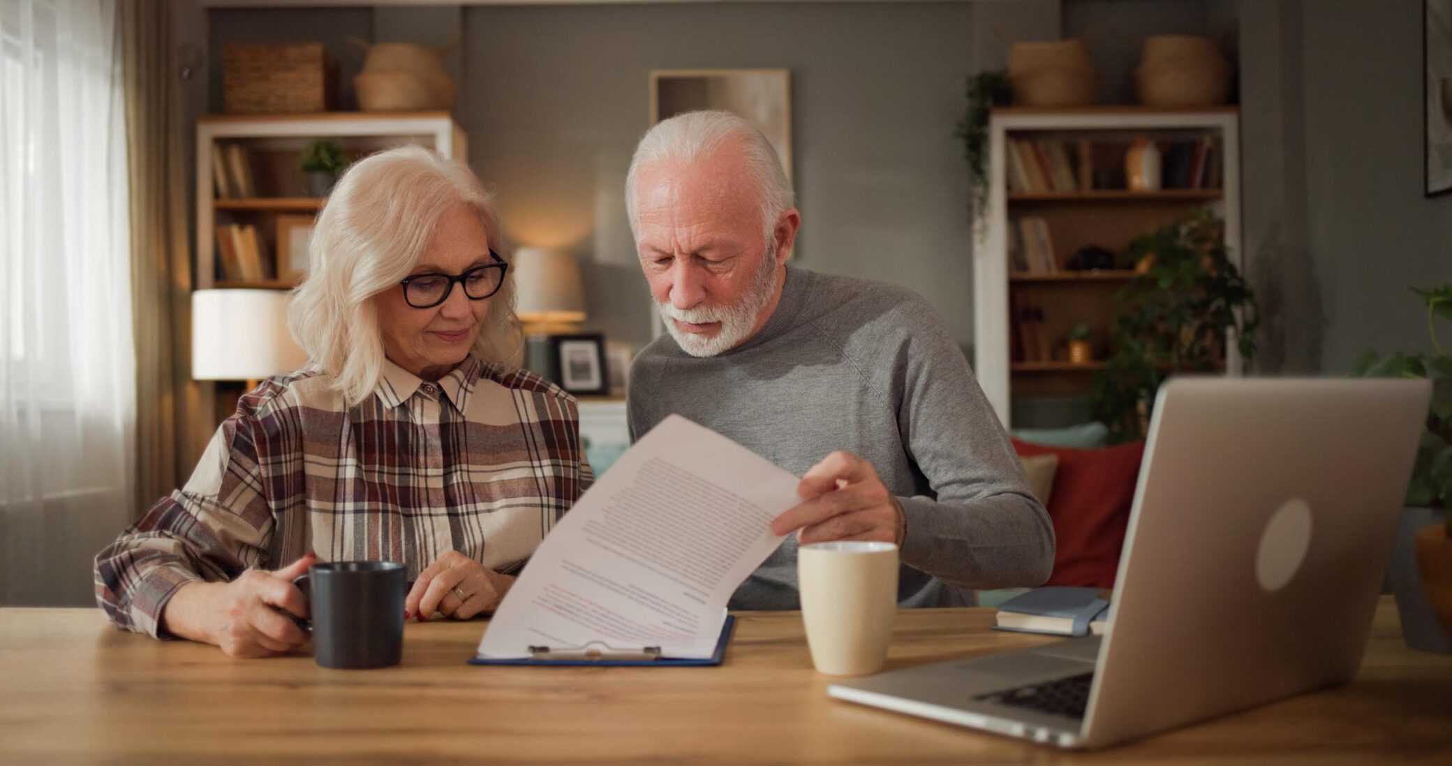 Senior couple reviewing financial documents while discussing final expense insurance